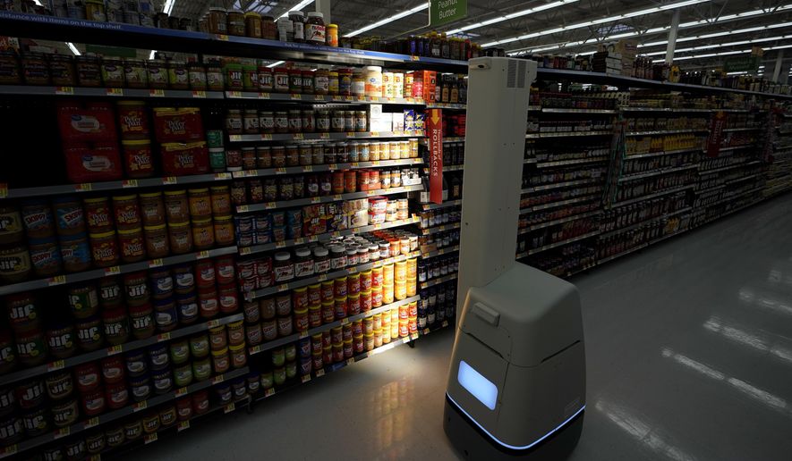 FILE - In this Nov. 9, 2018, file photo, a Bossa Nova robot scans shelves to help provide associates with real-time inventory data at a Walmart Supercenter in Houston. Robots aren’t replacing everyone, but a quarter of U.S. jobs will be severely disrupted as artificial intelligence accelerates the automation of today’s work, according to a new Brookings Institution report. The report published Thursday, Jan. 24, 2019, says roughly 36 million Americans hold jobs with “high exposure” to automation, meaning about 70 percent of their work tasks could soon be performed by machines using current technology. (AP Photo/David J. Phillip, File)