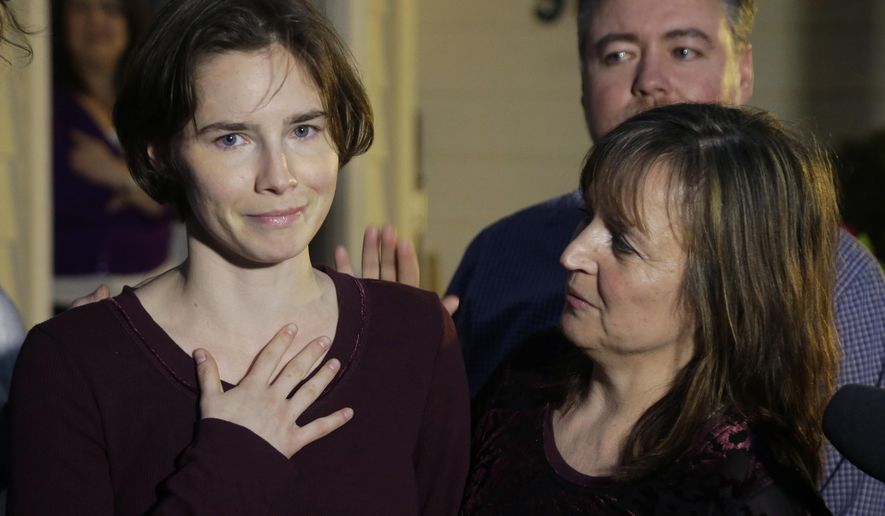 FILE - In this Friday, March 27, 2015 file photo, Amanda Knox, left, talks to reporters as her mother, Edda Mellas, right, looks on outside Mellas&#39; home in Seattle. Europe&#39;s human rights court has ordered Italy to pay Amanda Knox around 18,000 euros ($20,000) in financial damages for police failure to provide legal assistance and a translator during questioning following the Nov. 1, 2007 killing of her British roommate. The European Human Rights Court in Strasbourg, France, has ruled on Thursday, Jan. 24, 2019 that Italy must pay Knox 10,400 euros damages plus 8,000 euros for costs and expenses. (AP Photo/Ted S. Warren, file)