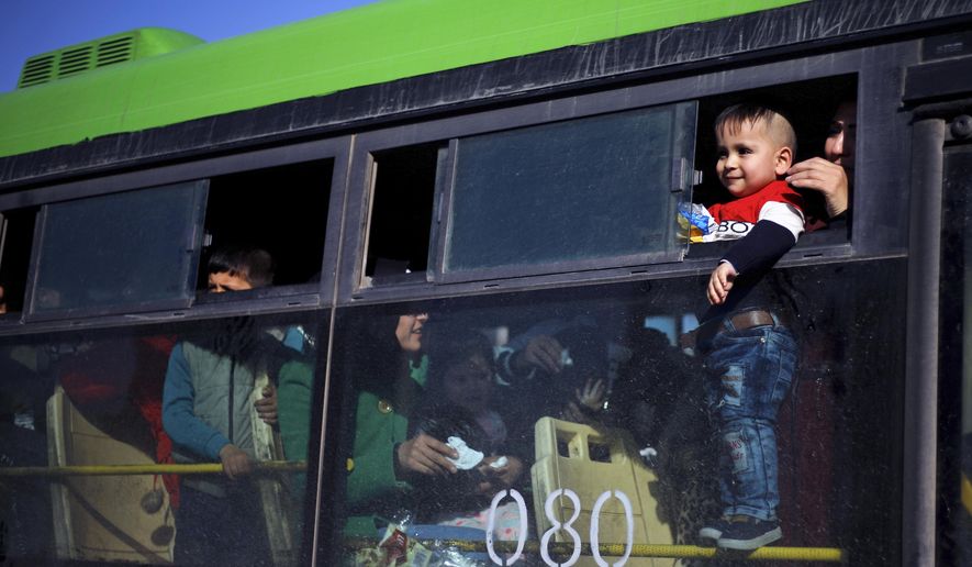 A refugee child looks out of a bus window that will take them home to Syria, in the northern Beirut suburb of Burj Hammoud, Lebanon, Thursday, Jan. 24, 2019. Hundreds of Syrian refugees in Lebanon have gone back to Syria. Lebanon is hosting about 950,000 registered Syrian refugees. That&#x27;s according to the U.N. refugee agency. The government estimates the true number of Syrian refugees in the country at 1.5 million. (AP Photo/Bilal Hussein)