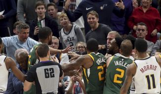 Utah Jazz and Denver Nuggets players get into a scuffle during an NBA basketball game in Salt Lake City, Wednesday, Jan. 23, 2019. Utah Jazz forward Derrick Favors (15) and Denver Nuggets forward Mason Plumlee (24) were ejected from the game. (Scott G Winterton/Deseret News via AP)