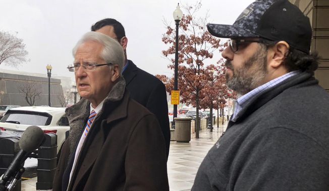 Attorney Larry Klayman, left, talks to the media, as Andrew Stettner, right, stepson of conservative writer Jerome Corsi, looks on, outside the federal courthouse after Stettner testified before a grand jury, Thursday, Jan. 24, 2019 in Washington.  Stettner was questioned for about an hour Thursday at the federal courthouse in Washington. (AP Photo/Mike Balsamo)