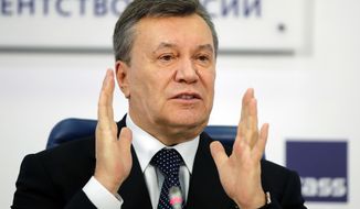 FILE - In this March 2, 2018 file photo, former Ukraine President Viktor Yanukovych gestures as he speaks at a news conference in Moscow. A court in the Ukrainian capital Kiev on Thursday Jan. 24, 2019, has found former president Viktor Yanukovych guilty of treason. (AP Photo/Pavel Golovkin, File)