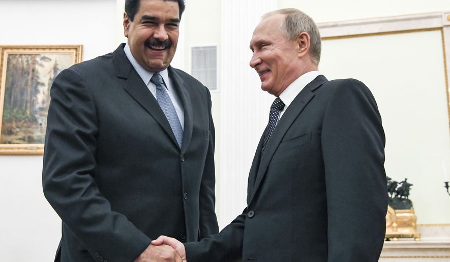 FILE - In this file pool photo taken on Oct. 4, 2017, Russian President Vladimir Putin, right, shakes hands with Venezuela&#39;s President Nicolas Maduro during their meeting at the Kremlin in Moscow, Russia. The crisis in Venezuela may have reached a new boiling point, but the geopolitical fault lines look familiar. Russia, China and Iran have thrown their support behind embattled Maduro, while the U.S., Canada and their allies in Western Europe are backing opposition leader Juan Guaido as interim president. (Yuri Kadobnov/Pool Photo via AP, File)