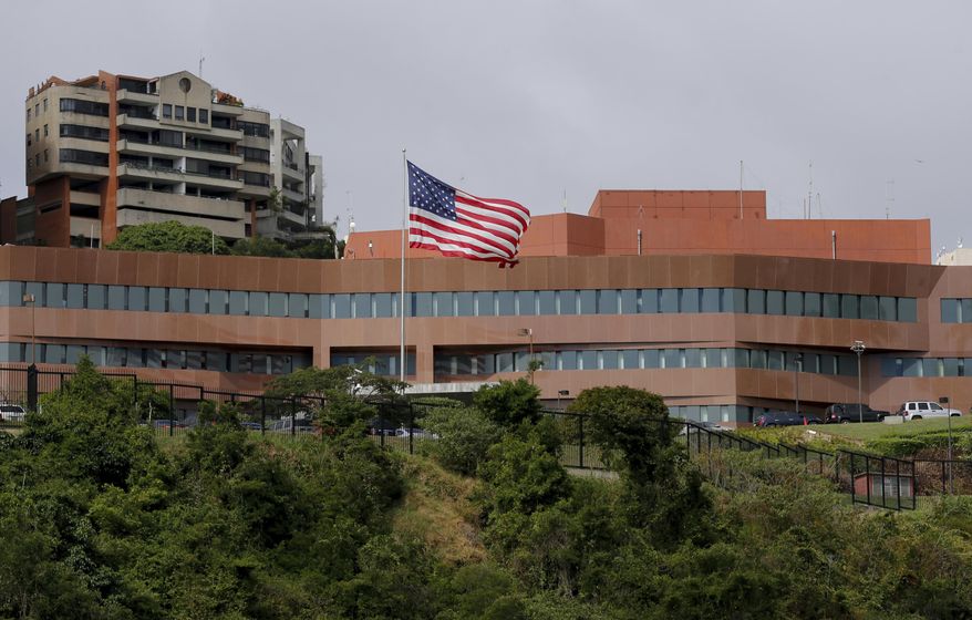 A U.S flag flies outside the U.S. embassy in Caracas, Venezuela, Thursday, Jan. 24, 2019. Venezuelans headed into uncharted political waters Thursday, with the young leader of a newly united and combative opposition claiming to hold the presidency and socialist President Nicolas Maduro digging in for a fight with the Trump administration. (AP Photo/Fernando Llano)