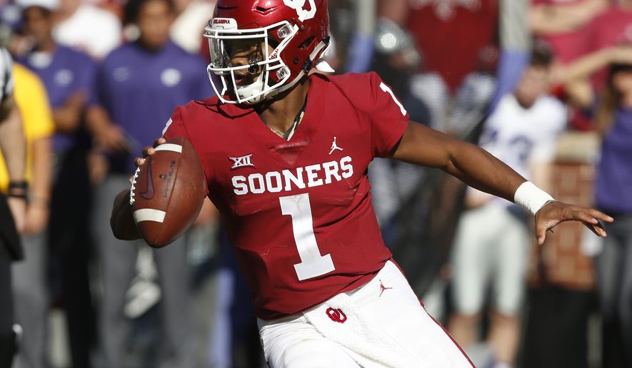 File - In this Oct. 27, 2018, file photo, Oklahoma quarterback Kyler Murray maneuvers during the team's NCAA college football game against Kansas State in Norman, Okla. The Oakland Athletics remain hopeful of seeing Heisman Trophy winner Murray in their baseball uniform when spring training begins next month. While the Oklahoma quarterback declared for the NFL draft last week, the prized outfielder could report to As spring training in Mesa, Arizona--and he has an invite to big league camp. (AP Photo/Sue Ogrocki, File)