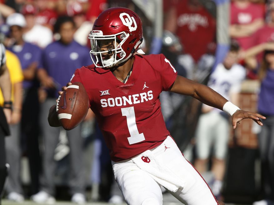 File - In this Oct. 27, 2018, file photo, Oklahoma quarterback Kyler Murray maneuvers during the team's NCAA college football game against Kansas State in Norman, Okla. The Oakland Athletics remain hopeful of seeing Heisman Trophy winner Murray in their baseball uniform when spring training begins next month. While the Oklahoma quarterback declared for the NFL draft last week, the prized outfielder could report to As spring training in Mesa, Arizona--and he has an invite to big league camp. (AP Photo/Sue Ogrocki, File)