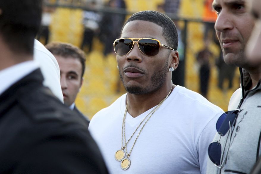 FILE- In this March 13, 2015 file photo, rapper Nelly approaches the stage for a concert in Irbil, northern Iraq. The St. Louis-based rapper is asking the federal court in his hometown to dismiss a British woman's lawsuit alleging that he sexually assaulted her after a concert in England. The lawsuit filed in November 2018 accused Nelly, whose real name is Cornell Haynes Jr., of an assault in December 2017. (AP Photo/Seivan M. Salim, File)