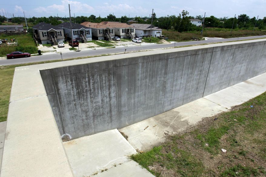 FILE - In this May 15, 2012 file photo, the new levee wall constructed with reinforced concrete, is shown at one of the breach sites from Hurricane Katrina, in the Lower 9th Ward in New Orleans. Louisiana's estimated share of the costs for federal levee work in the New Orleans area has ballooned to $3 billion because the U.S. Army Corps of Engineers is charging interest on the debt. Louisiana's first payment is due in August 2020, with $100 million estimated to be owed annually for 30 years.(AP Photo/Gerald Herbert, File)