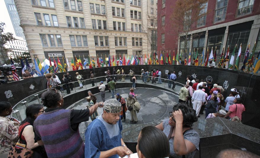 FILE- In this Oct. 5, 2007 file photo, visitors tour the African Burial Ground National Monument in New York. The site is run by the National Park Service and was closed during the 35-day partial government shutdown. It reopened on Saturday, Jan. 26, 2019. The National Park Service is preparing to resume operations nationally, but deputy director P. Daniel Smith says schedules for individual sites may vary depending on staff size and complexity. (AP Photo/Bebeto Matthews, File)