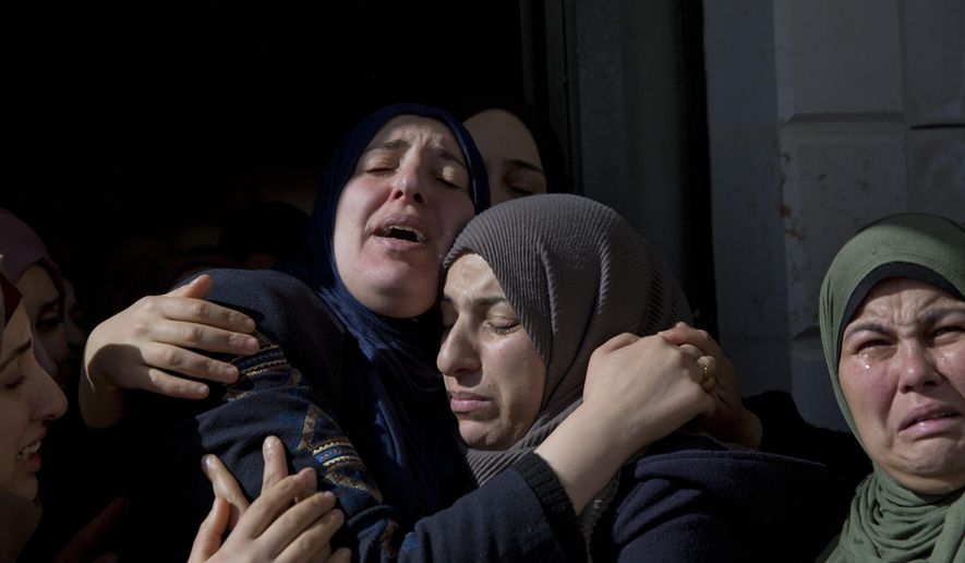 Inas Hamed, center left cries among other mourners during the funeral of her son Ayman Hamed, 18 at the family house in the West Bank village of Silwad, near Ramallah Saturday, Jan. 26, 2019. Israeli soldiers shot and killed the Palestinian teen and wounded another as a group of young men hurled stones at the troops. (AP Photo/Nasser Nasser)