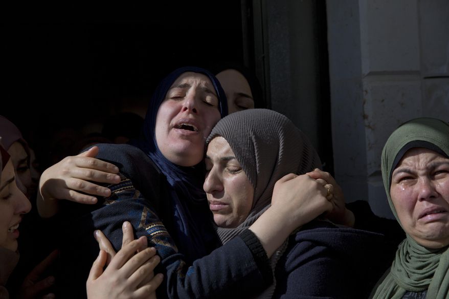 Inas Hamed, center left cries among other mourners during the funeral of her son Ayman Hamed, 18 at the family house in the West Bank village of Silwad, near Ramallah Saturday, Jan. 26, 2019. Israeli soldiers shot and killed the Palestinian teen and wounded another as a group of young men hurled stones at the troops. (AP Photo/Nasser Nasser)