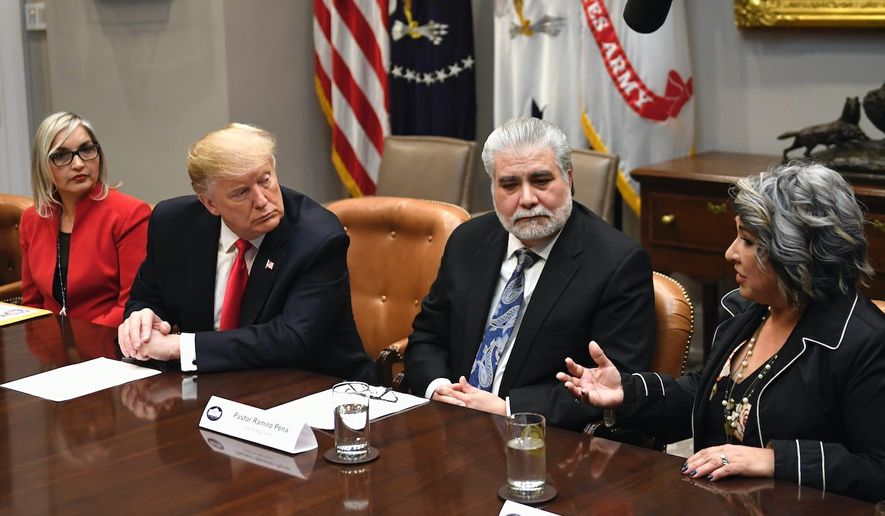 President Trump listens intently to Pastor Norma Urrabazo, flanked by Lourdes Aguirre (left) and pastor Ramiro Pena at a meeting Friday. (ASSOCIATED PRESS)