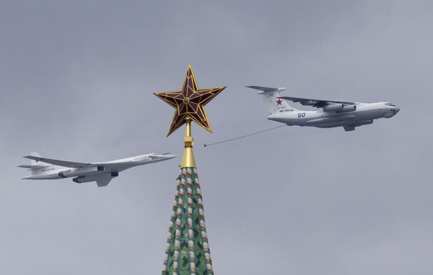 Russian IL-78 air-to-air refuelling tanker, right, demonstrates in-flight refuelling of a Tu-160 strategic bomber as they fly over Moscow's Kremlin during a general rehearsal for the Victory Day military parade which will take place at Moscow's Red Square on May 9 to celebrate 71 years after the victory in WWII in Moscow, Russia, on Thursday, May 5, 2016. (AP Photo/Ivan Sekretarev)