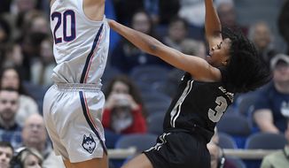 Connecticut&#x27;s Olivia Nelson-Ododa blocks a shot attempt by Central Florida&#x27;s Diamond Battles, right, during the first half of an NCAA college basketball game, Sunday, Jan. 27, 2019, in Hartford, Conn. (AP Photo/Jessica Hill)
