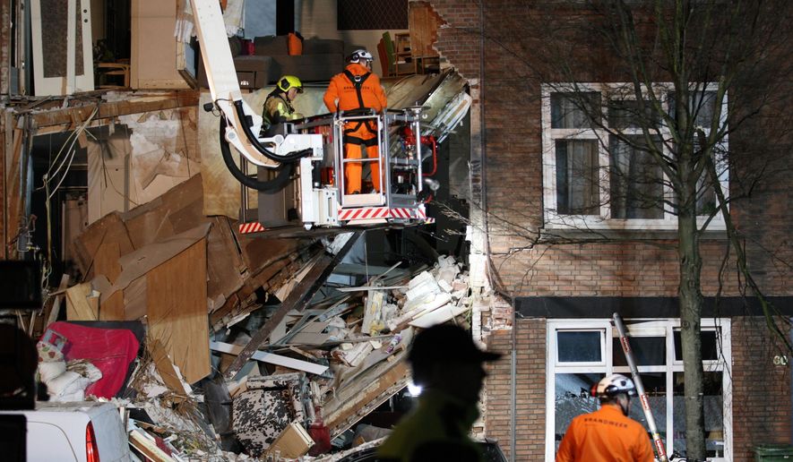 Authorities respond after a three-story home collapsed in The Hague, Netherlands on Sunday, Jan. 27, 2019. Police at the scene said a gas explosion was being explored as a possible cause of what tore off the home's front and demolished the dwelling in a residential neighborhood on Sunday. (AP Photo/Wong Maye-E)