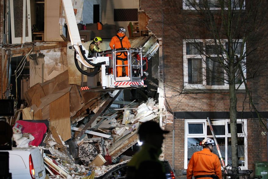 Authorities respond after a three-story home collapsed in The Hague, Netherlands on Sunday, Jan. 27, 2019. Police at the scene said a gas explosion was being explored as a possible cause of what tore off the home's front and demolished the dwelling in a residential neighborhood on Sunday. (AP Photo/Wong Maye-E)