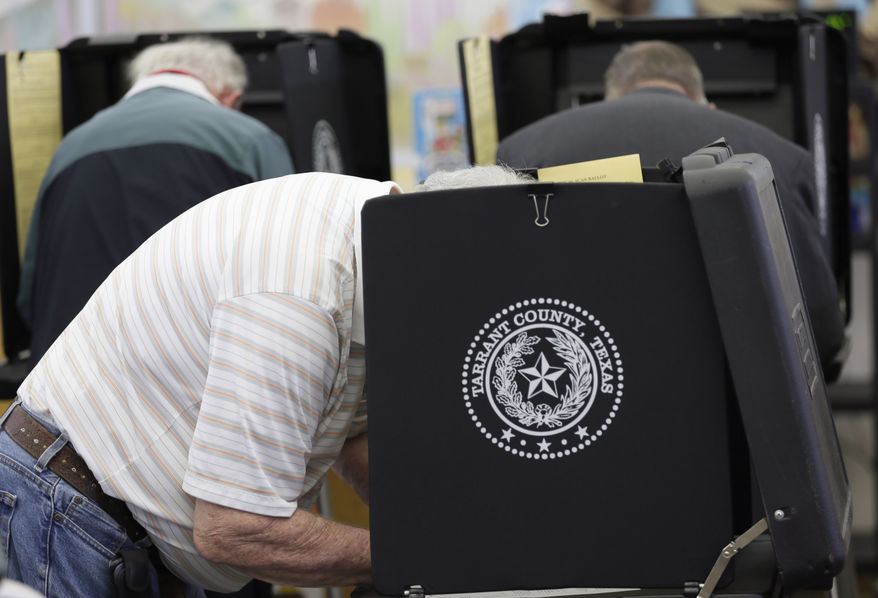 FILE - In this March 1, 2016 file photo, voters make their choice in the ballot booth during primary election day at Sherrod Elementary School in Arlington, Texas. Officials in Texas, Oklahoma and Louisiana say they've denied a request by Russian officials to be present at polling stations during the November general election. The U.S. State Department's spokesman says Russia hasn't participated in an international mission to observe elections, so its effort to do so on the state level represents "nothing more than a PR stunt." (AP Photo/LM Otero, File)