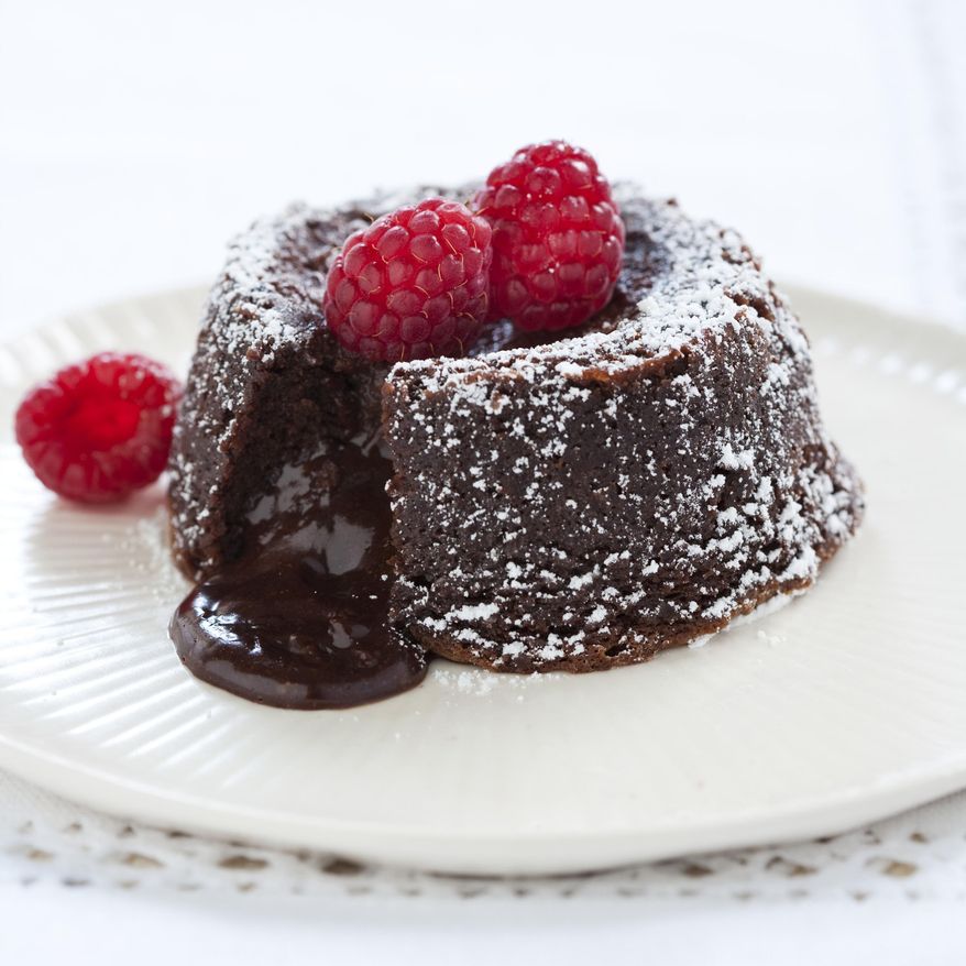 This undated photo provided by America's Test Kitchen in January 2019 shows a Fallen Chocolate Cake in Brookline, Mass. This recipe appears in the cookbook "The Perfect Cake." (Keller + Keller/America's Test Kitchen via AP)