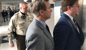 Sen. Rand Paul, center, enters an elevator during a break in jury selection for his civil trial in Bowling Green, Ky., Monday, Jan. 28, 2019. Jury selection began Monday in Paul&#39;s lawsuit against Rene Boucher for the 2017 attack that left the senator with multiple broken ribs. Paul is seeking up to $500,000 in compensatory damages and up to $1 million in punitive damages. (AP Photo/Bruce Schreiner)