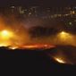 This image provided by Justin Engel shows a fire in Cape Town, South Africa, Sunday Jan. 27, 2019. Cape Town officials say they have controlled a fire that blazed overnight around the city&#39;s iconic Lion&#39;s Head hill, injuring one man. The Cape Town area remains on high alert because of hot, dry conditions and windy weather. (Justin Engel via AP)