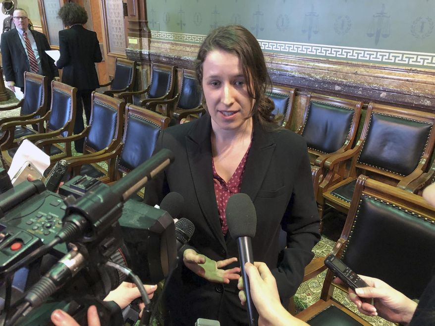 In this Jan. 24, 2019 photo, Democratic candidate for Iowa House Kayla Koether answers questions from the reporters at the state Capitol in Des Moines, Iowa, following a committee meeting where her challenge of the November election was rejected by Republicans who have a majority on the panel. The Republican-led Iowa House has voted to reject 29 absentee mail ballots cast in a northeast Iowa House district handing a Republican who won by nine votes the seat in the first contested election to go before the Legislature in 27 years. (AP Photo/David Pitt)