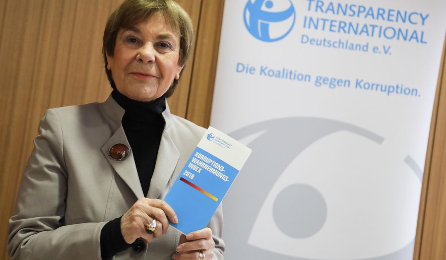 Edda Mueller, chairwoman of Transparency International Germany e.V. poses for the media with the Corruption Perceptions Index 2018, prior to the presentation of the yearly report at a news conference in Berlin, Germany, Tuesday, Jan. 29, 2019. The flyer reading: 'Corruption Perceptions Index 2018'. (AP Photo/Markus Schreiber)