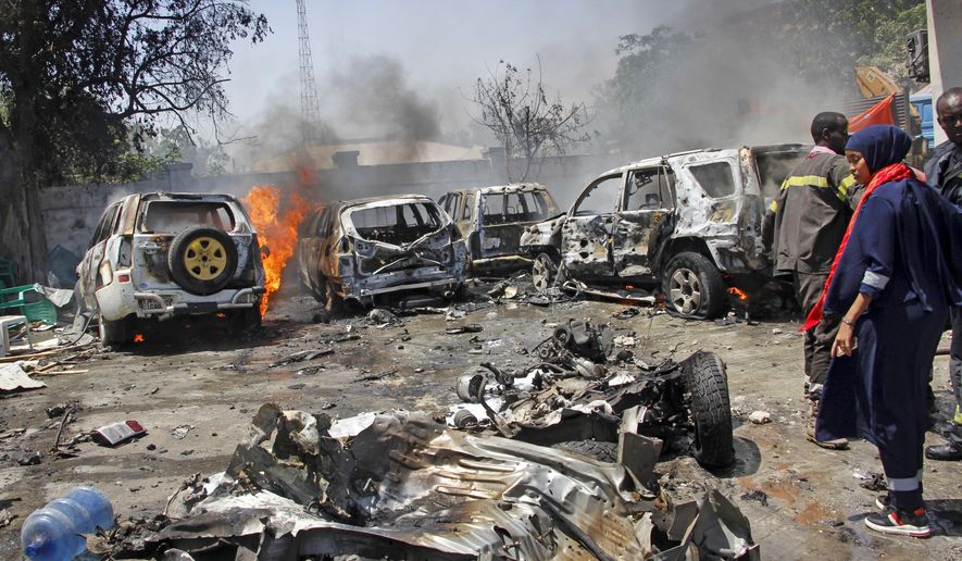 Security forces and emergency services attend the scene of a blast in the capital Mogadishu, Somalia, Tuesday Jan. 29, 2019. The blast took place inside a petrol station located near to the Ministry of Petroleum. (AP Photo/Farah Abdi Warsameh)