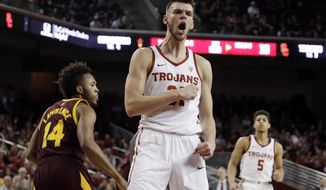 FILE - In this Saturday, Jan. 26, 2019, file photo, Southern California forward Nick Rakocevic, center, reacts after scoring against Arizona State during the first half of an NCAA college basketball game in Los Angeles. Rakocevic has emerged as one of the top players during the first half of the Pac-12 Conference season, leading the league in double-doubles as the Trojans go into a key game on Wednesday at Washington. (AP Photo/Marcio Jose Sanchez, File)