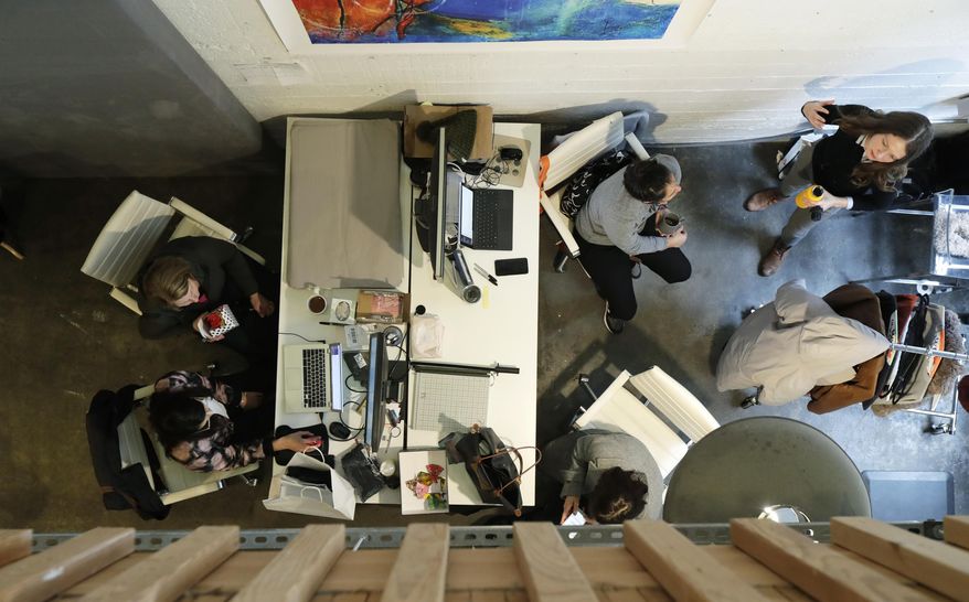 In this Jan. 11, 2019, photo, women work in a lower-level space at The Riveter, a women-focused shared workspace facility in Seattle. The Riveter is one of a growing number of women-only and women-focused workspaces around the country. The Riveter has four other locations in Seattle and Los Angeles and plans to open in Austin, Texas, in March. (AP Photo/Ted S. Warren)