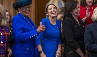 Rep. Alma Adams D-N.C., left, with Rep. Alexandria Ocasio-Cortez, D-N.Y., smiles during an event to advocate for the Paycheck Fairness Act on the 10th anniversary of President Barack Obama signing the Lilly Ledbetter Fair Pay Act, at the Capitol in Washington, Wednesday, Jan. 30, 2019. The legislation, a top tier issue for the new Democratic majority in the House, would strengthen the Equal Pay Act of 1963 and guarantee that women can challenge pay discrimination and hold employers accountable.(AP Photo/J. Scott Applewhite)