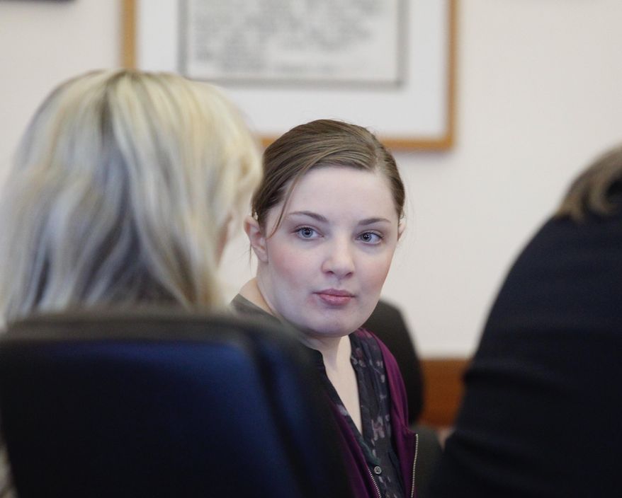 Cheyanne Harris talks with her attorney during her court appearance on Wednesday, Jan. 30, 2019 in Le Mars, Iowa. Harris, the mother of a baby whose lifeless body was found in an infant swing wearing a maggot-infested diaper is standing trial in his death. Court records say Harris has pleaded not guilty to first-degree murder and child endangerment resulting in death. The trial was moved to Le Mars in Plymouth County from Chickasaw County because of publicity. (Jeff Reinitz/The Courier via AP)
