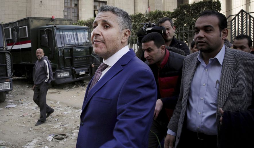 FILE - In this Jan. 1, 2015 file photo, Egyptian lawyer Negad al-Borai, center left, leaves the high court after a hearing, in Cairo, Egypt. Al-Borai said Wednesday, Jan. 30, 2019 that Egypt has rounded up at least six activists in the last couple of days in a wave of arrests coinciding with the anniversary of the 2011 uprising. Authorities have waged a sweeping crackdown on dissent in recent years, reversing freedoms won in the popular uprising that toppled longtime autocrat Hosni Mubarak. (AP Photo/Nariman El-Mofty, File)