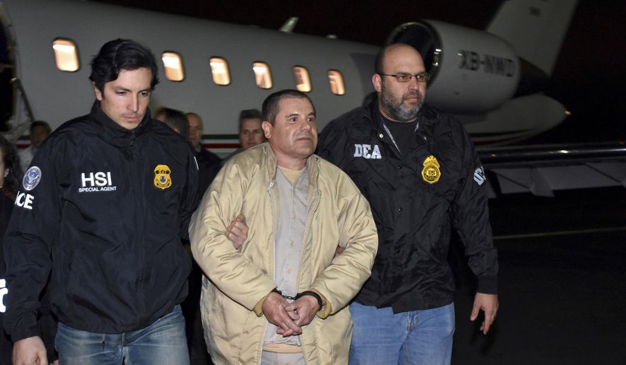 FILE - In this Jan. 19, 2017 file photo provided U.S. law enforcement, authorities escort Joaquin "El Chapo" Guzman, center, from a plane to a waiting caravan of SUVs at Long Island MacArthur Airport, in Ronkonkoma, N.Y. A U.S. jury is set to hear closing arguments on Wednesday, Jan. 30, 2019 in Guzman's high-profile drug trafficking trial. (U.S. law enforcement via AP, File)
