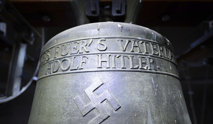 FILE - In this May 19, 2017 file photo a church bell with the inscription "Everything for the fatherland Adolf Hitler" and a swastika is pictured in the town church in Herxheim am Berg, western Germany. An appeals court has rejected the complaint of a Jewish man against the German town’s Herxheim am Berg decision to allow the bell dedicated to Adolf Hitler to continue to hang in a church tower. (Uwe Anspach/dpa via AP, file)