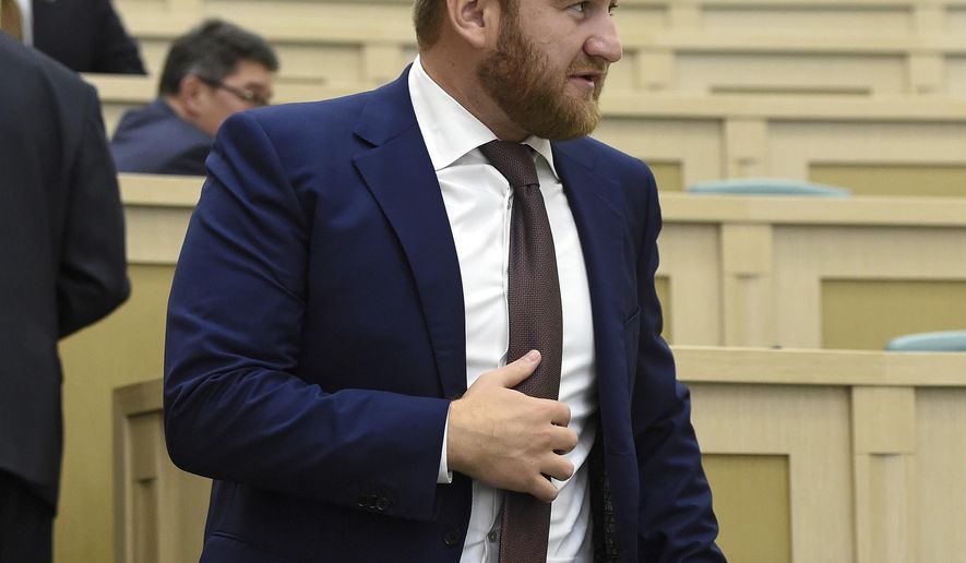 In this photo taken on Wednesday, Sept. 28, 2016, Rauf Arashukov, who represents the Karachaevo-Cherkessiya region in the North Caucasus, stands at the Federation Council, in Moscow, Russia. A Russian lawmaker suspected of contracting two murders was detained on Wednesday at the Russian parliament in front of stunned deputies after he tried to escape but was stopped by the parliament speaker. (Dmitry Dukhanin/Kommersant Photo via AP) RUSSIA OUT