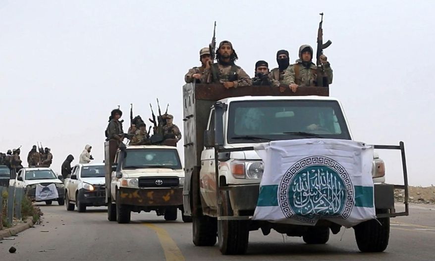 This photo released Dec. 4, 2018, by the al-Qaeda-affiliated Ibaa News Agency, shows al-Qaeda-linked fighters driving their vehicles during a military drill in northern Syria. (Ibaa News Agency, via AP) ** FILE **
