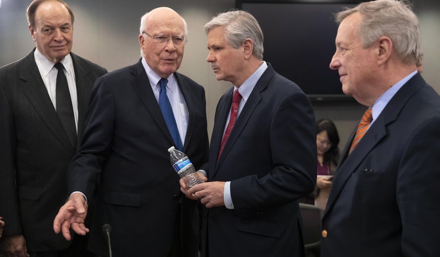 From left, Sen. Richard Shelby, R-Ala., chair of the Senate Appropriations Committee, Sen. Patrick Leahy, D-Vt., ranking member of the Senate Appropriations Committee, Sen. John Hoeven, R-N.D., and Sen. Dick Durbin, D-Ill., the assistant Democratic leader in the Senate, greet each other as a bipartisan group of House and Senate bargainers meet to craft a border security compromise in hope of avoiding another government shutdown, at the Capitol in Washington, Wednesday, Jan. 30, 2019. . (AP Photo/J. Scott Applewhite)
