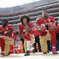 In this Oct. 2, 2016, file photo, from left, San Francisco 49ers outside linebacker Eli Harold, quarterback Colin Kaepernick and safety Eric Reid kneel during the national anthem before an NFL football game against the Dallas Cowboys in Santa Clara, Calif. (AP Photo/Marcio Jose Sanchez, File)