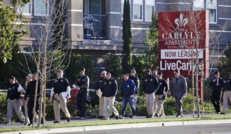 In this March 3, 2015, file photo, federal agents enter an upscale apartment complex where authorities say a birth tourism business charged pregnant women $50,000 for lodging, food and transportation, in Irvine, Calif. On Thursday, Jan. 31, 2019, authorities announced they have charged 20 people in an unprecedented crackdown on businesses that helped hundreds of Chinese women travel to the United States to give birth to American citizen children. (AP Photo/Jae C. Hong, File)