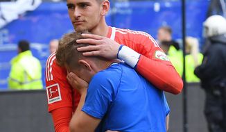 File--- Picture taken May 12, 2018 shows Hamburg&#39;s goalkeeper Julian Pollersbeck and Lewis Holtby after being relegated in Hamburg, Germany. (Marvin Ibo Güngör/dpa via AP)