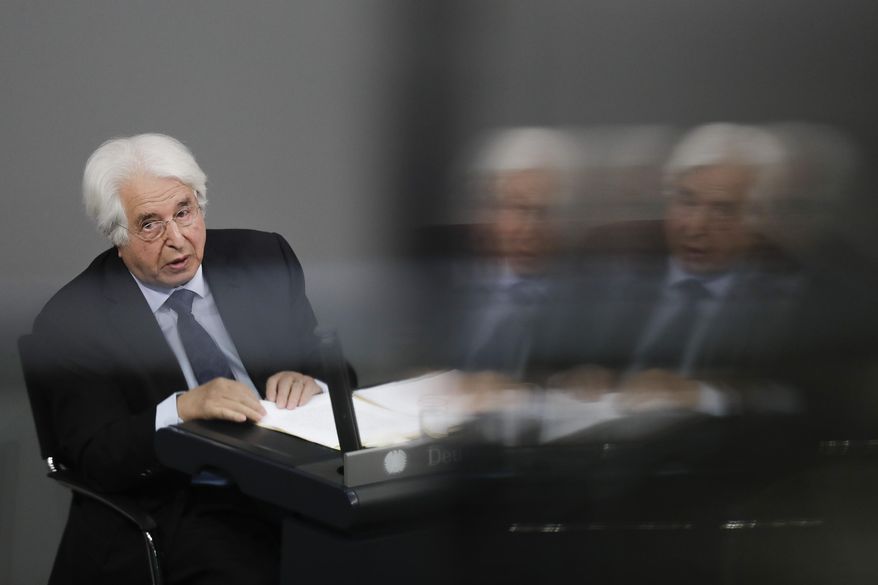 In this photo taken with reflections at a window at the visitors tribune, Israeli Historian Saul Friedlaender delivers his speech during a remembrance event of the parliament Bundestag to commemorate the victims of the Holocaust at the Reichstag building in Berlin, Thursday, Jan. 31, 2019. (AP Photo/Markus Schreiber)