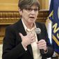 FILE - In this Jan. 24, 2019 file photo, Kansas Gov. Laura Kelly answers questions from reporters during a news conference at the Statehouse in Topeka, Kansas. Republican lawmakers in Kansas have advanced tax relief and pension proposals that would thwart Democratic Gov. Kelly&#39;s plans for boosting spending on public schools, quickly setting up a test of whether she can build bipartisan coalitions in the GOP-dominated Legislature. A Senate committee Thursday, Jan. 31, 2019, endorsed a bill designed to prevent Kansas residents and businesses from paying more income taxes to the state because of changes in federal tax laws at the end of 2017. (AP Photo/John Hanna, File)