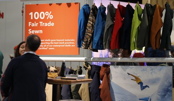 In this Wednesday, Jan. 30, 2019, photograph, a sign indicating items that were 100-percent fair trade-sewn marks a rack of jackets and shells in the Patagonia exhibit at the Outdoor Retailer &amp;amp; Snow Show in the Colorado Convention Center in Denver. Major players in the outdoor industry jumped into the political fight over national monuments two years ago and now have added climate change and sustainable manufacturing to their portfolio. (AP Photo/David Zalubowski)