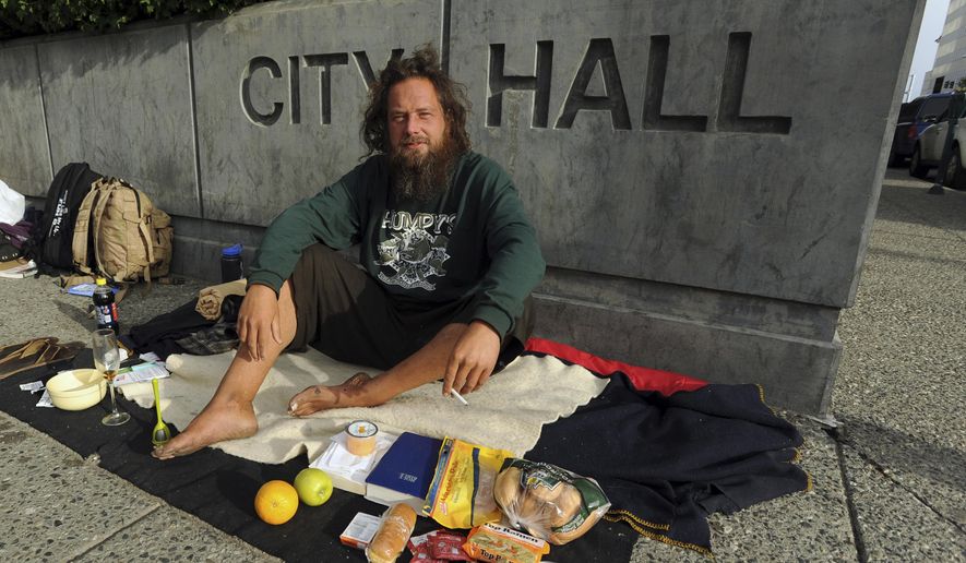 FILE - In this July 1, 2011, file photo, John Martin camps out in front of City Hall in downtown Anchorage, Alaska, to protest the city's practice of clearing homeless camps. Martin has been detained since August 2018 in Russia after his dinghy washed ashore there in his attempt to sail from Alaska to China. He expects to be back in Alaska on Sunday, Feb. 3, 2019. (Bob Hallinen/Anchorage Daily News via AP, File)