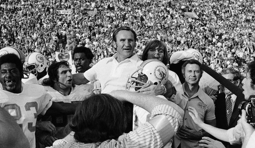 FILE - In this Jan. 14, 1973 file photo, Miami Dolphins coach Don Shula is carried off the field after his team won NFL football Super Bowl game with a 14-7 victory over Washington Redskins in Los Angeles. Yes, it's time for another story about the Patriots trying to accomplish something nobody has done since the '72 Dolphins. But not THAT story. Eleven seasons after falling one win short of matching Miami's perfection, New England is trying to become the first team since those famed Dolphins to follow a loss in the Super Bowl with a title the very next year. (AP Photo/File)