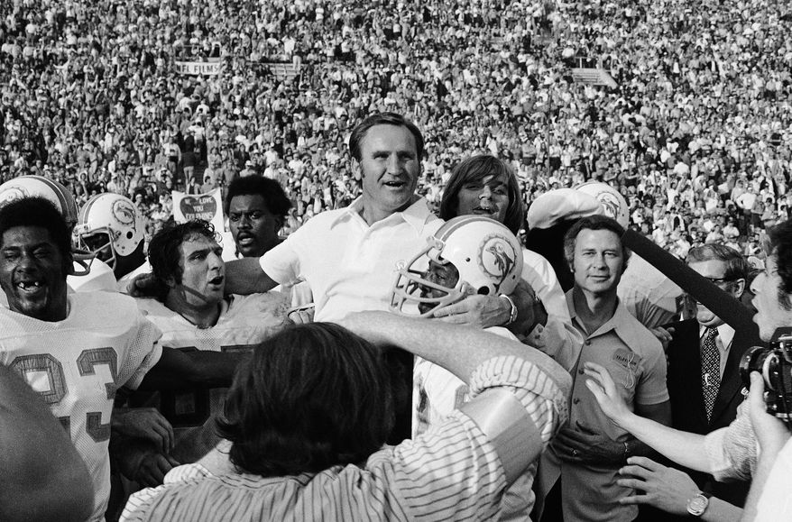 FILE - In this Jan. 14, 1973 file photo, Miami Dolphins coach Don Shula is carried off the field after his team won NFL football Super Bowl game with a 14-7 victory over Washington Redskins in Los Angeles. Yes, it's time for another story about the Patriots trying to accomplish something nobody has done since the '72 Dolphins. But not THAT story. Eleven seasons after falling one win short of matching Miami's perfection, New England is trying to become the first team since those famed Dolphins to follow a loss in the Super Bowl with a title the very next year. (AP Photo/File)