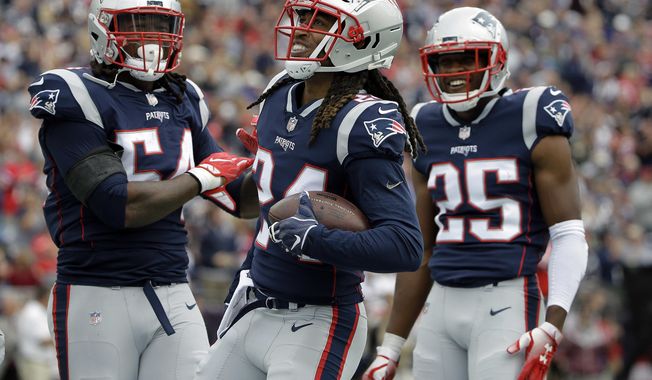 FILE - In this Sept. 9, 2018, file photo, New England Patriots defensive back Stephon Gilmore, center, celebrates his interception with Dont&#x27;a Hightower, left, and Eric Rowe, right, during the first half of an NFL football game against the Houston Texans in Foxborough, Mass. 2018 has been a signature season for one of the quietest players in their locker room. Gilmore earned All-Pro honors for the first time in his career and taken the leadership reins of a secondary that lost Malcolm Butler in free agency this past offseason. (AP Photo/Steven Senne, File)