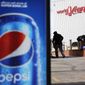 A Pepsi advertisement stands outside the World of Coca-Cola museum as a vendor stocks his kiosk in Atlanta, Wednesday, Jan. 30, 2019. The Patriots and the Rams aren&#39;t the only ones battling for Super Bowl supremacy this week. Pepsi and Coke also seem to be squaring off. Pepsi, an official NFL sponsor of Super Bowl 53, has invaded Coke&#39;s home turf, its headquarters are in Atlanta. (AP Photo/David Goldman)