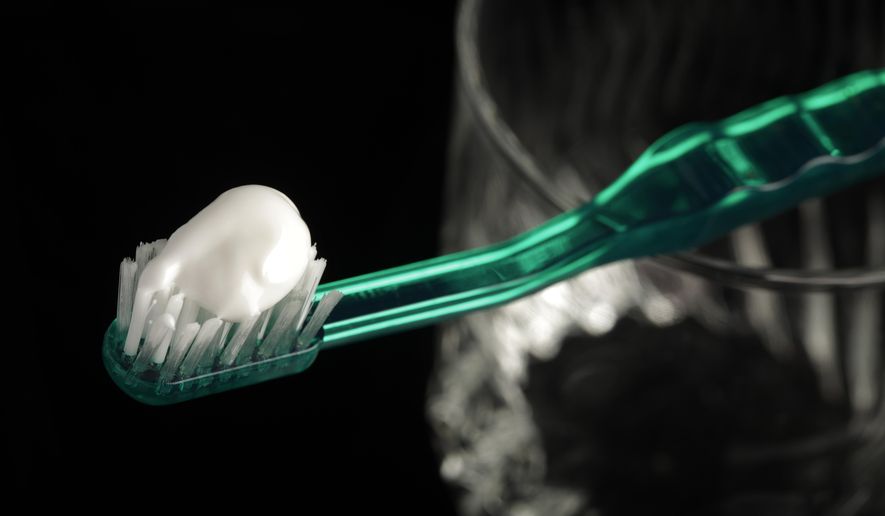 FILE - This Wednesday, Oct. 28, 2009 file photo shows toothpaste on a toothbrush in Marysville, Pa. A report released by the Centers for Disease Control and Prevention on Thursday, Jan. 31, 2019, says too many young kids are using too much toothpaste, increasing their risk of streaky or splotchy teeth when they get older. (AP Photo/Carolyn Kaster, File)