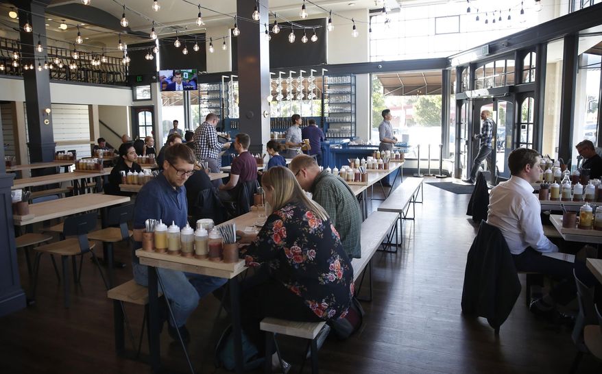 In this May 9, 2018, file photo, customers dine at the Wursthall Restaurant & Bierhaus in San Mateo, Calif. Patrons won't be served at the Silicon Valley restaurant if they wear a "Make America Great Again" baseball cap .J. Kenji Lopez-Alt is a chef-partner of the Wursthall restaurant in San Mateo and said in a tweet Sunday, Jan. 27, 2019, that he views the hats as symbols of intolerance and hate. (Michael Mayor/San Francisco Chronicle via AP, File)